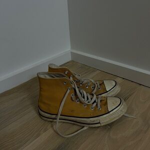 Well-loved yellow Converse high tops